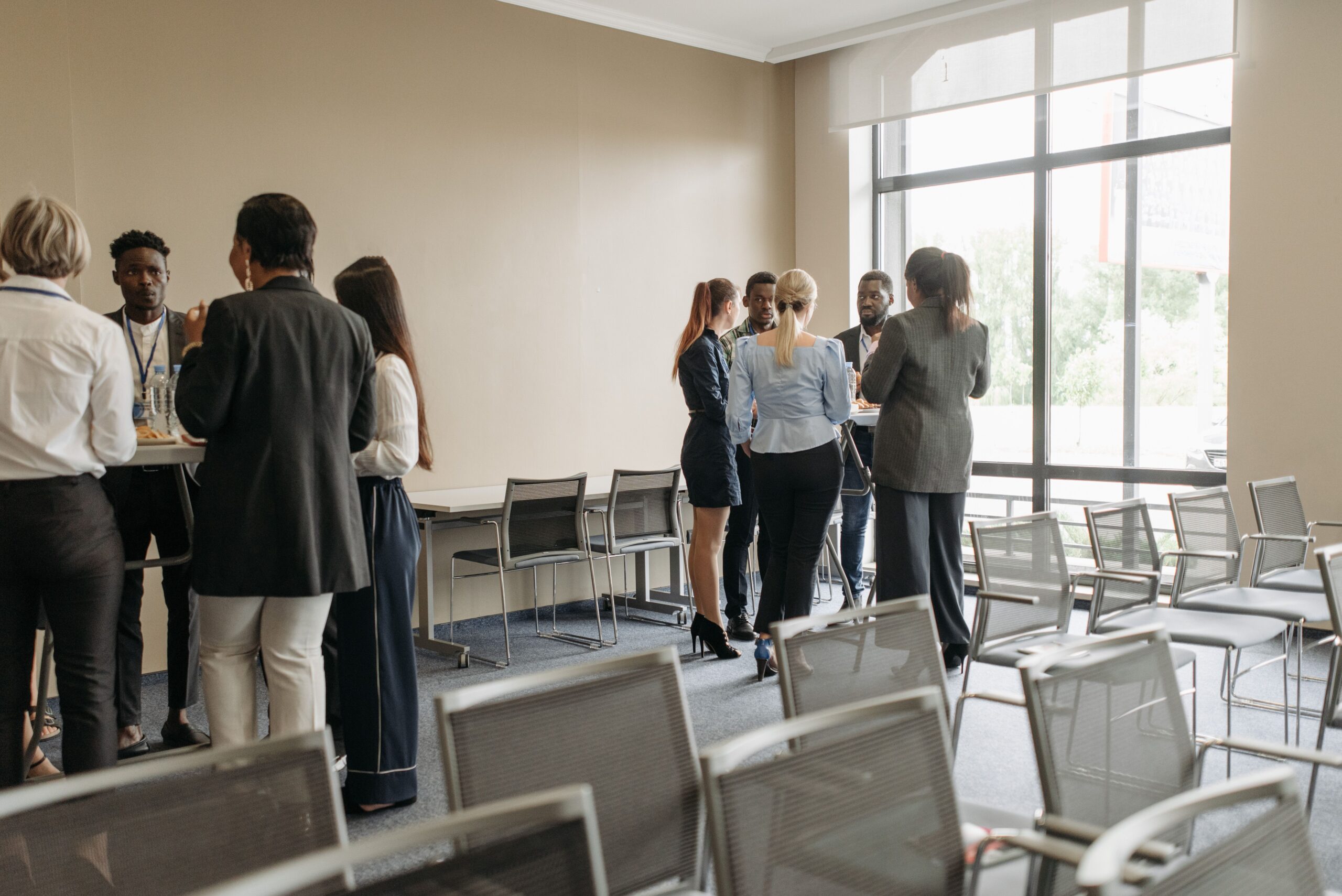 Professionals talking during a conference break. Photo by Pavel Danilyuk via Pexels.